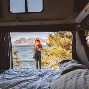 Jucy Condo Campervan – 4 Berth_door_open_in_front_of_lake