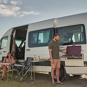 maui-ultima-2-berth-motorhome-exterior-couple-bbq